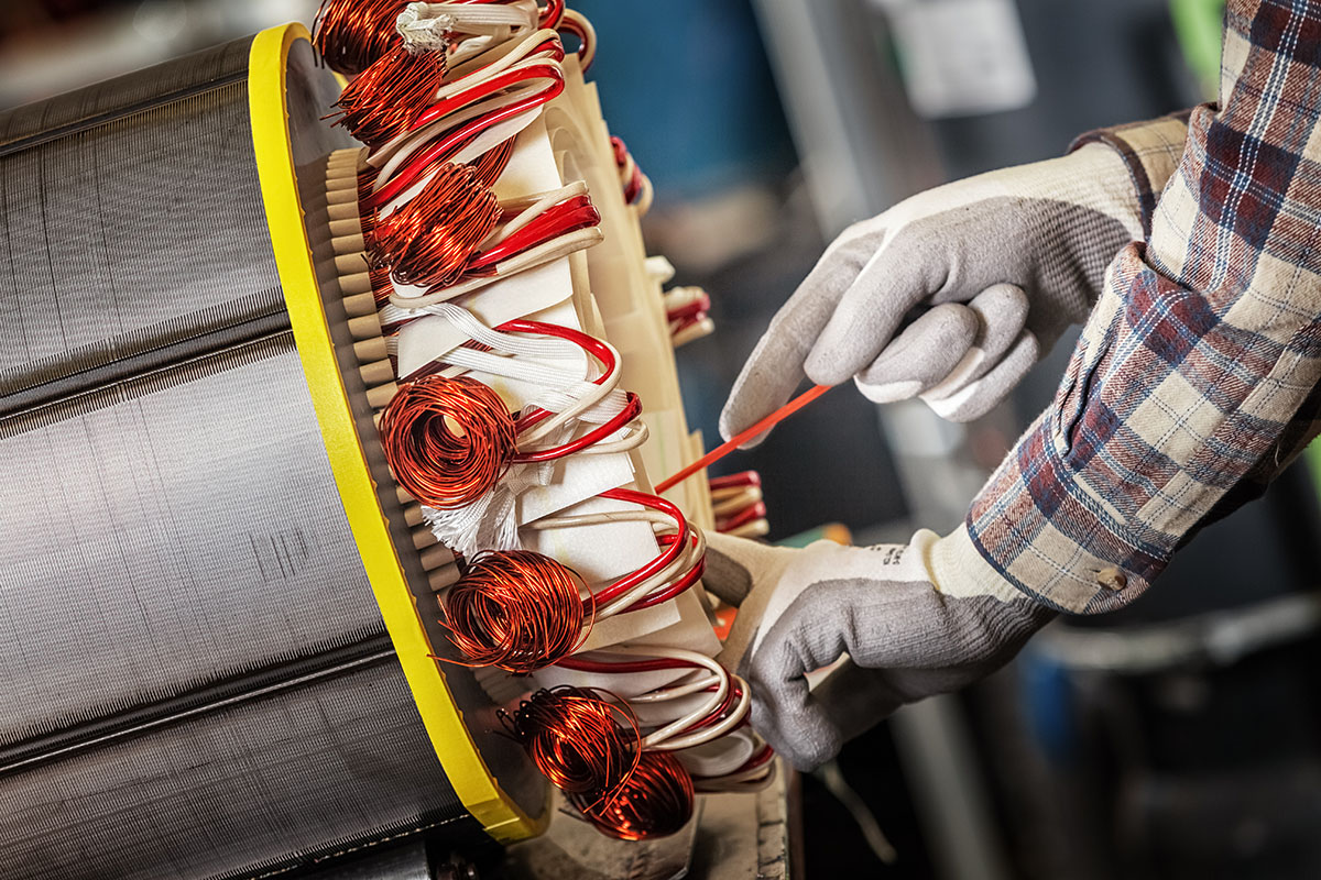 Skilled industrial worker assembling a large electric motor